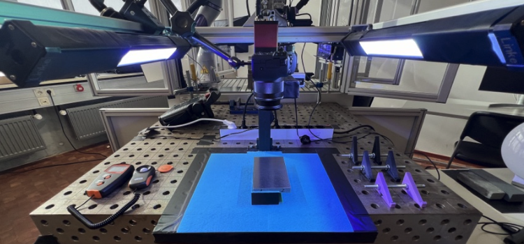 Photo of the KUKA robot rig, workpiece, and light bar setup